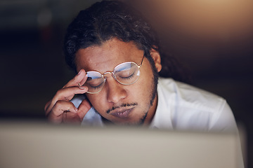 Image showing Businessman, headache and stress at computer at night in office working late on deadline. Tired entrepreneur person with glasses and hands on head for pain, burnout or depression and fatigue at work