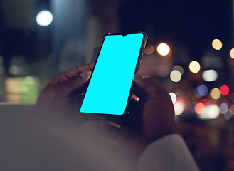 Image showing Hands, green screen on phone for communication and a business person closeup in a city at night. Marketing, contact and mockup space with an employee scrolling on a touchscreen for mobile advertising