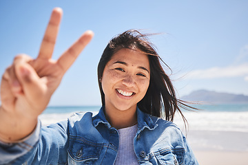 Image showing Portrait, woman and sign for peace on beach, holiday or profile picture from vacation in Indonesia on summer or break. Happy, face and smile at the ocean, sea or person travel in nature with freedom