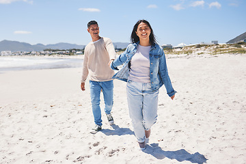 Image showing Love, happy and holding hands with couple at beach for travel, summer vacation and romance together. Smile, relax and bonding with man and woman walking on seaside holiday for care, date or honeymoon