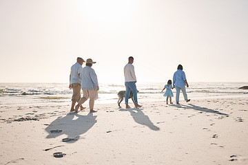 Image showing Summer, travel and walking with big family on beach for vacation, bonding and love. Freedom, care and relax with group of people on seaside holiday for generations, happiness and mockup space