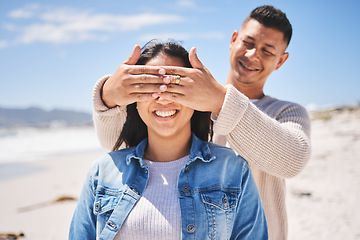 Image showing Surprise, cover eyes and people on beach with news, love and couple on romantic date, summer travel outdoor. Man, woman and marriage, secret announcement and bond, adventure and vacation in Mexico