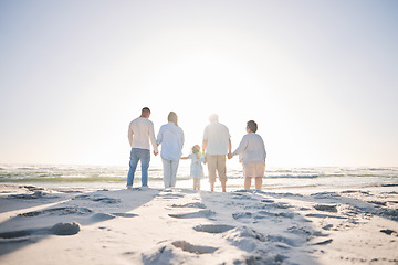 Image showing Summer, travel and holding hands with big family on beach for vacation, bonding and love. Freedom, care and relax with group of people walking at seaside holiday for generations, happiness and mockup