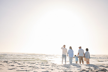 Image showing Space, travel and holding hands with big family on beach for vacation, bonding and love. Summer, care and relax with group of people walking at seaside holiday for generations, happiness and mockup