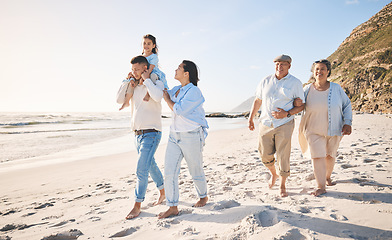 Image showing Summer, travel and love with big family on beach for vacation, bonding and fun. Freedom, care and relax with group of people walking at seaside holiday for generations, happiness and support together