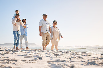 Image showing Summer, travel and relax with big family on beach for vacation, bonding and love. Freedom, care and support with group of people walking at seaside holiday for generations, happiness and mockup space