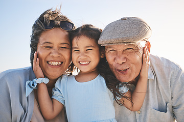 Image showing Smile, sky and portrait of a girl with her grandparents in nature on a family vacation or holiday. Happy, love and child holding her grandmother and grandfather with care on an outdoor weekend trip.