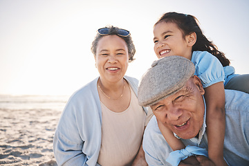 Image showing Fun, beach and girl playing with her grandparents on a family vacation, adventure or holiday. Happy, smile and child on a piggyback ride and bonding with her grandmother and grandfather by the ocean.