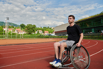 Image showing A person with disability in a wheelchair training tirelessly on the track in preparation for the Paralympic Games