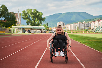 Image showing A woman with disablity driving a wheelchair on a track while preparing for the Paralympic Games