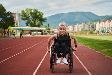 Image showing A woman with disablity driving a wheelchair on a track while preparing for the Paralympic Games