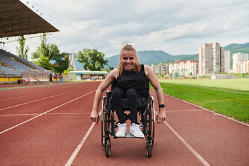 Image showing A woman with disablity driving a wheelchair on a track while preparing for the Paralympic Games