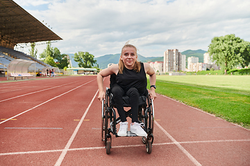 Image showing A woman with disablity driving a wheelchair on a track while preparing for the Paralympic Games