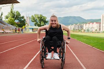 Image showing A woman with disablity driving a wheelchair on a track while preparing for the Paralympic Games