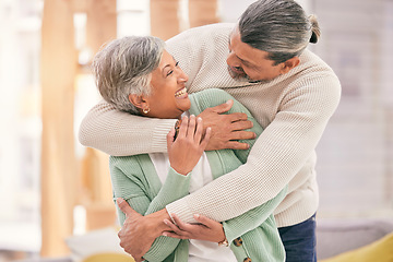Image showing Happy elderly couple, hug and relax with love in living room bonding, romance or embrace together at home. Mature man and woman smile in happiness for loving relationship, affection or commitment