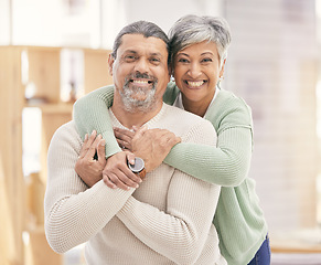 Image showing Happy elderly couple, portrait and hug with love in living room bonding, romance or embrace together at home. Mature man or woman smile in happiness for loving relationship, affection or commitment