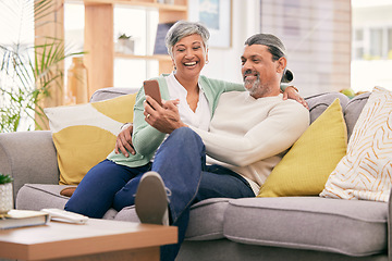 Image showing Phone, happy and mature couple on sofa with smile for social media post, internet and browse website. Marriage, love and man and woman on smartphone in living room for bonding, funny meme and relax