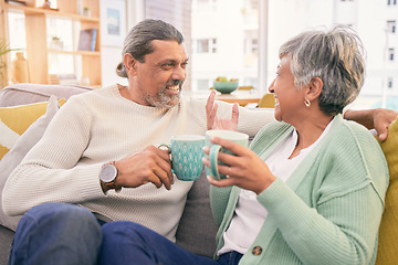 Image showing Coffee, conversation and mature couple on sofa for bonding, healthy relationship and connection. Marriage, love and happy man and woman drinking tea on couch to relax in discussion, talking and chat