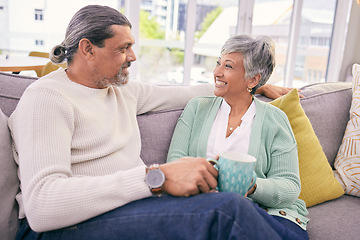 Image showing Relax, conversation and mature couple on sofa for bonding, healthy relationship and connection with coffee. Marriage, love and happy man and woman drinking tea on couch in discussion, talking or chat