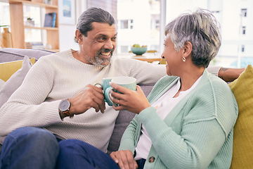 Image showing Coffee, talking and mature couple on sofa for bonding, healthy relationship and connection. Marriage, love and happy man and woman drinking tea on couch to relax in discussion, conversation and chat