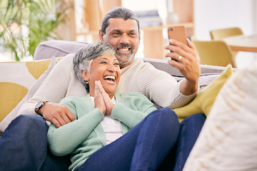 Image showing Laughing, selfie and a senior couple with a phone on the sofa for communication, social media or a video call. Smile, house and an elderly man and woman taking a photo with a mobile on the couch