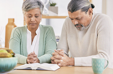 Image showing Praying, book and senior couple at home with bible study and religion together in marriage. Prayer, faith and elderly people with worship, learning and christian solidarity with love and care