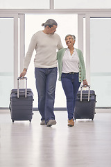 Image showing Mature couple, luggage and walking in airport lobby, happy and travel together, tourist holiday and vacation. Man, woman smile and suitcase for flight, immigration journey and global airplane trip