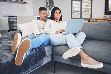 Image showing Laptop, online shopping and couple relaxing on a sofa in the living room of their modern house. Happy, technology and young man and woman networking or browsing on the internet with computer at home.