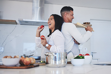 Image showing Happy couple, food and fun cooking in kitchen together for healthy eating or natural nutrition at home. Man and woman enjoying teamwork or bonding in happiness for breakfast, lunch or supper meal