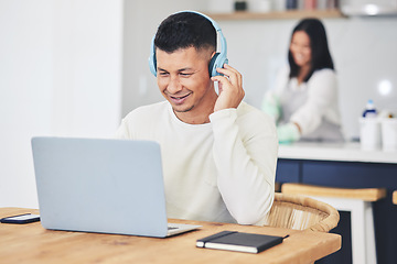 Image showing Remote work from home, headphones and man with a laptop, business owner and typing with research. Person, copywriter or freelancer streaming audio, kitchen and pc with headset, project or connection