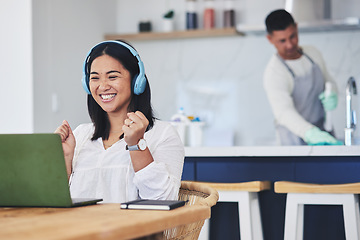 Image showing Laptop, music and remote work with a winner woman in her home reading news about a bonus or promotion. Computer, celebration and headphones with a happy young entrepreneur cheering freelance success