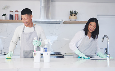 Image showing Happy couple, housekeeper and cleaning table in kitchen, chemical equipment or detergent in bacteria and germ removal at home. Man and woman wiping surface with cloth together in hygiene to sanitise