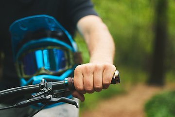 Image showing Hand, handle and cycling with helmet, sports and person in forest, mockup space and closeup. Mountain bike, biker outdoor and travel with adventure, fitness and ready to ride, exercise and training