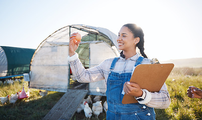 Image showing Agriculture, farm and a woman with an egg for inspection and a clipboard for quality control. Farming, sustainability and a poultry farmer person with organic produce outdoor for growth or production
