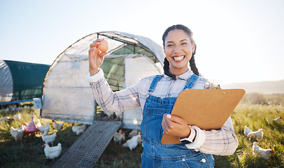 Image showing Farm, poultry and a woman with an egg for inspection and a clipboard for quality control. Chicken farming, sustainability and portrait of farmer person with organic produce outdoor for agriculture