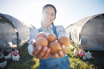 Image showing Woman with eggs, smile and chickens on farm with grass, sunshine and countryside field with sustainable business. Agriculture, poultry farming and farmer holding produce for food, nature and animals.