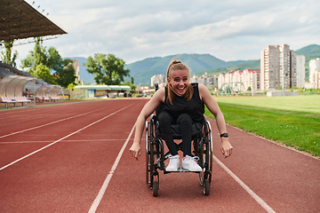 Image showing A woman with disablity driving a wheelchair on a track while preparing for the Paralympic Games