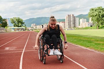 Image showing A woman with disablity driving a wheelchair on a track while preparing for the Paralympic Games