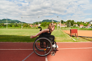 Image showing A woman with disablity driving a wheelchair on a track while preparing for the Paralympic Games