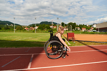 Image showing A woman with disablity driving a wheelchair on a track while preparing for the Paralympic Games