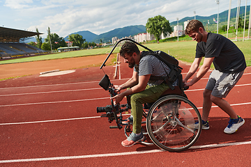 Image showing A cameraman filming the participants of the Paralympic race on the marathon course