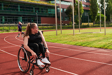 Image showing A Muslim woman in a burqa running together with a woman in a wheelchair on the marathon course, preparing for future competitions.