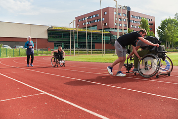 Image showing A cameraman filming the participants of the Paralympic race on the marathon course