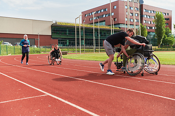 Image showing A cameraman filming the participants of the Paralympic race on the marathon course