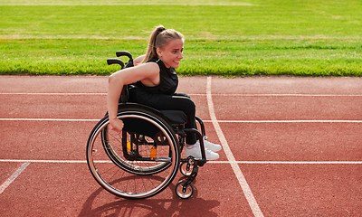 Image showing A woman with disablity driving a wheelchair on a track while preparing for the Paralympic Games