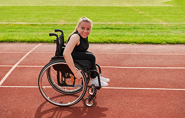 Image showing A woman with disablity driving a wheelchair on a track while preparing for the Paralympic Games