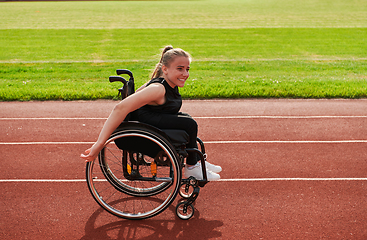 Image showing A woman with disablity driving a wheelchair on a track while preparing for the Paralympic Games