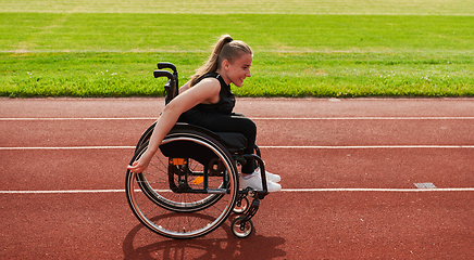 Image showing A woman with disablity driving a wheelchair on a track while preparing for the Paralympic Games