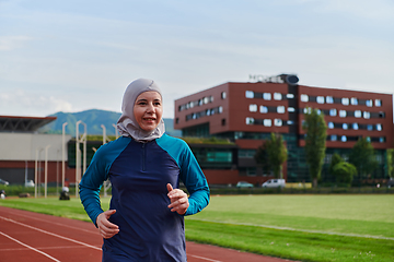 Image showing A muslim woman in a burqa sports muslim clothes running on a marathon course and preparing for upcoming competitions