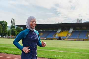 Image showing A muslim woman in a burqa sports muslim clothes running on a marathon course and preparing for upcoming competitions